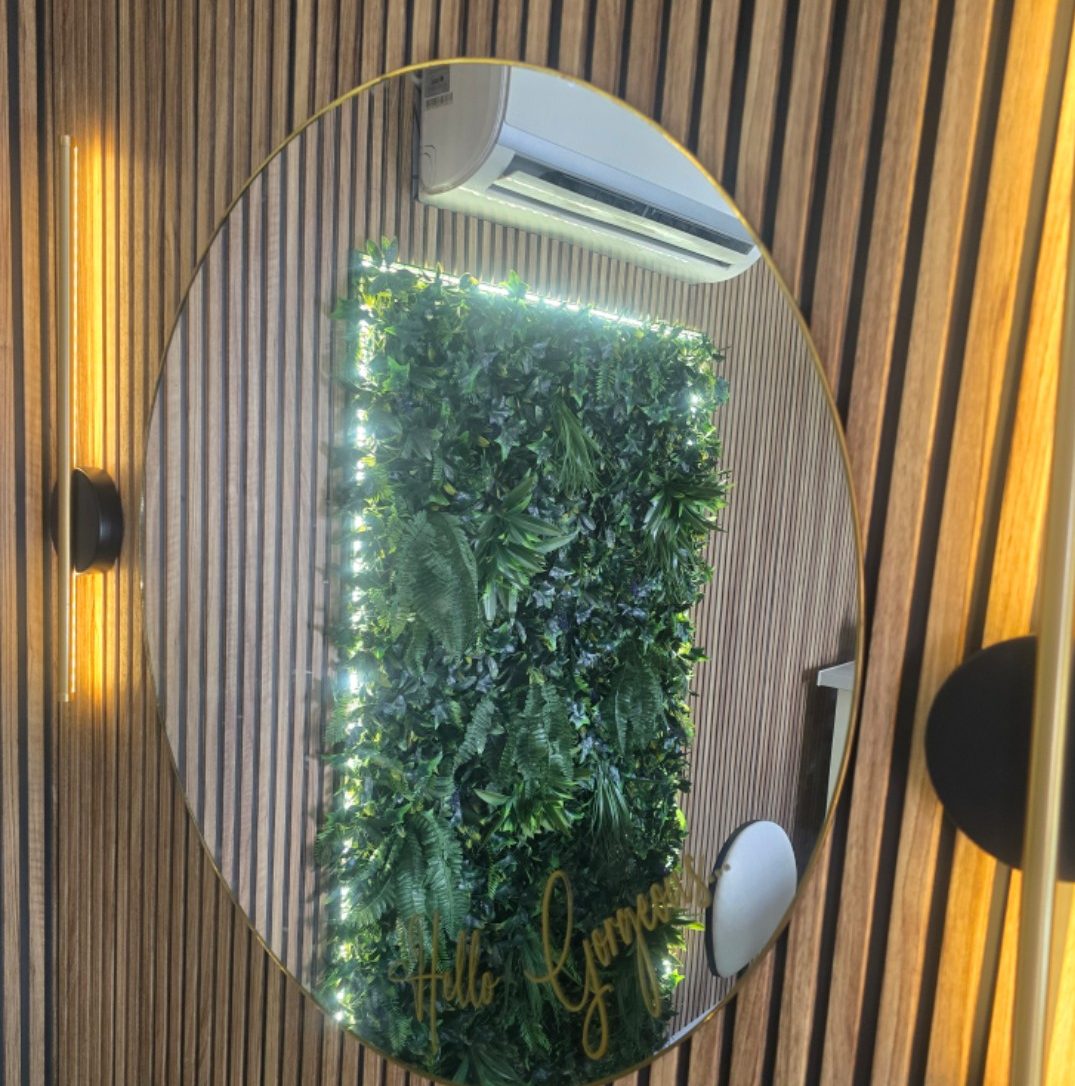 Hello Gorgeous mirror on the slatted wood wall