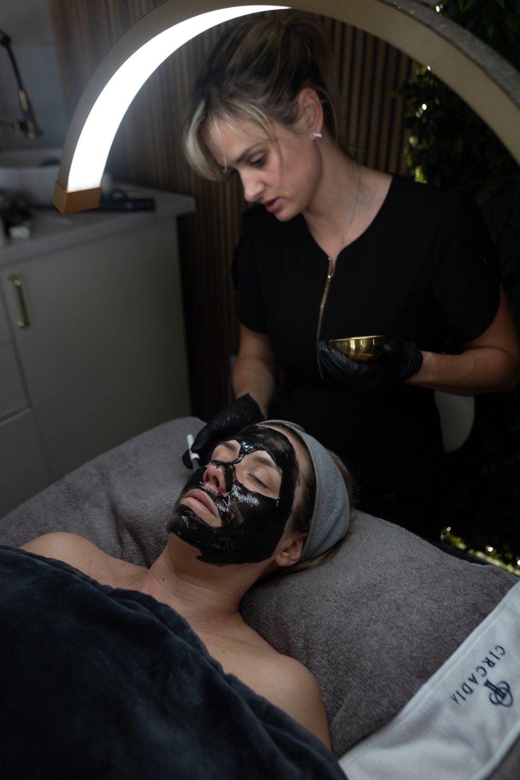 Sarah applying a charcoal mask